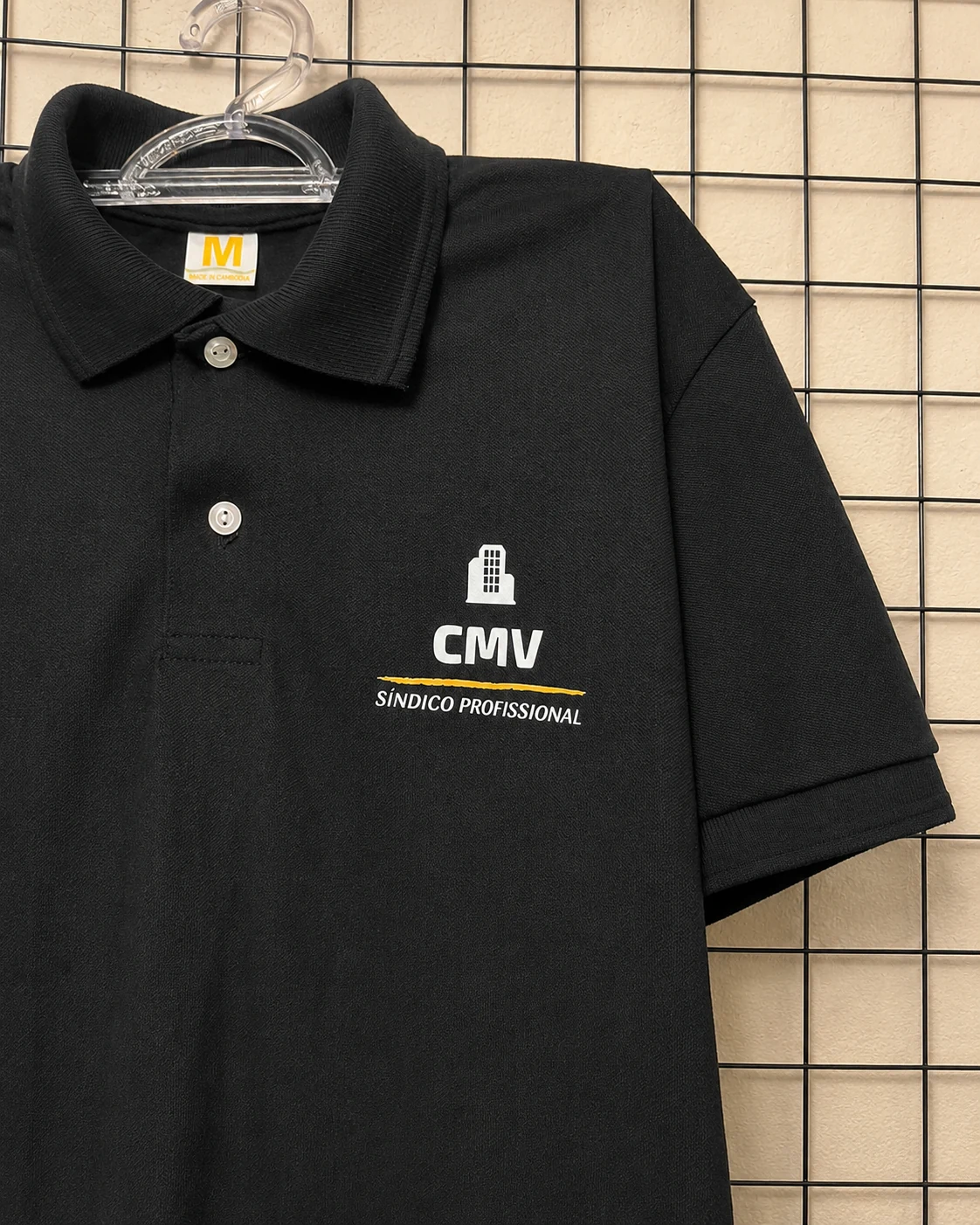 Detalhe de camisa polo preta CMV Síndico Profissional personalizada